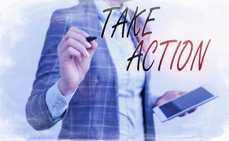 Handwriting text writing Take Action. Conceptual photo to do somethingoract in order to get a particular result Business woman pointing in empty space with pen and mobile phoneの写真素材