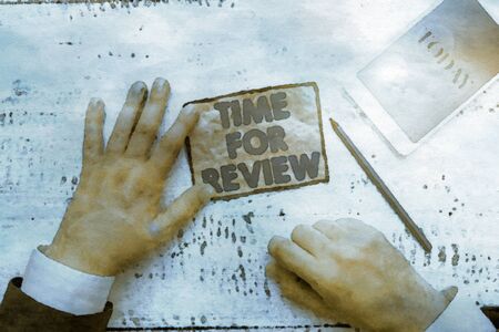 Text sign showing Time For Review. Business photo text Evaluation Feedback Moment Perforanalysisce Rate Assess Hand hold note paper near writing equipment and modern smartphone deviceの写真素材