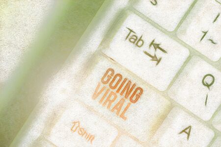 Writing note showing Going Viral. Business concept for something that that spreads rapidly through a populationの写真素材