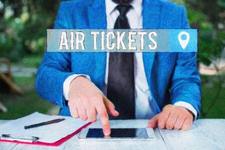Writing note showing Air Tickets. Business concept for individual is entitled to a seat on a flight on an aircraft Businessman with pointing finger in front of himの写真素材