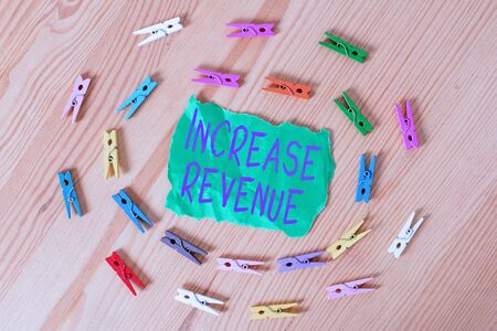 Word writing text Increase Revenue. Business photo showcasing increase in a company s is sales from one period to the next Colored clothespin papers empty reminder wooden floor background officeの写真素材