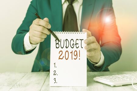 Text sign showing Budget 2019. Business photo showcasing estimate of income and expenditure for current year Man holds empty paper with copy space in front of him Copy Spaceの写真素材