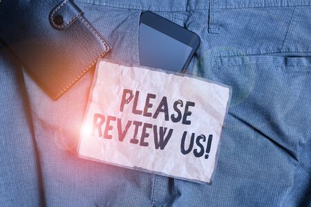 Conceptual hand writing showing Please Review Us. Concept meaning situation or system is formal examination by showing authority Smartphone device inside trousers front pocket with walletの写真素材