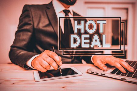 Writing note showing Hot Deal. Business concept for An agreement through which one of the paties is offered and accept Male human wear formal clothes present use hitech smartphoneの写真素材