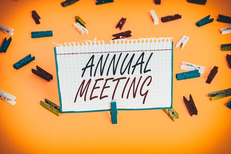 Writing note showing Annual Meeting. Business concept for yearly meeting of the general membership of an organization Colored clothespin papers empty reminder yellow floor background officeの写真素材
