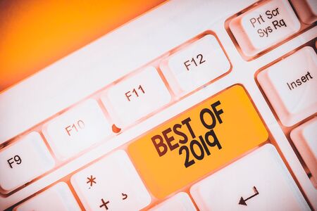 Conceptual hand writing showing Best Of 2019. Concept meaning great and marvelous things and events happened on 2019 White pc keyboard with note paper above the white backgroundの写真素材