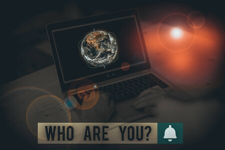 Writing note showing Who Are You Question. Business concept for asking about someone identity or demonstratingal information Picture photo network scheme with modern smart device and Elements of this image furnished by NASAの写真素材