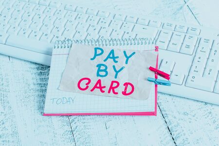 Conceptual hand writing showing Pay By Card. Concept meaning Payments on credit Debit Electronic Virtual Money Shopping notebook reminder clothespin with pinned sheet light woodenの写真素材