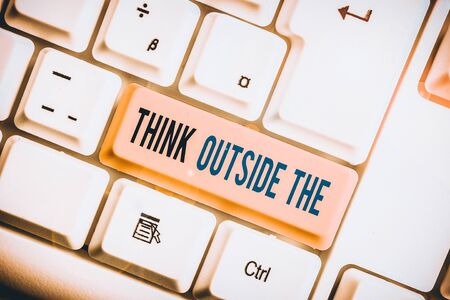 Text sign showing Think Outside The. Business photo text Creative Thinking Looking in different perspective White pc keyboard with empty note paper above white background key copy spaceの写真素材