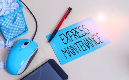 Conceptual hand writing showing Express Maintenance. Concept meaning damage is immediately debited to repairs and maintenance crumpled paper in bin placed next to modern gadget and stationaryの写真素材