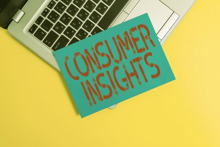Text sign showing Consumer Insights. Business photo showcasing understanding customers based on their buying behavior Part view trendy metallic laptop clipboard paper sheet colored backgroundの写真素材
