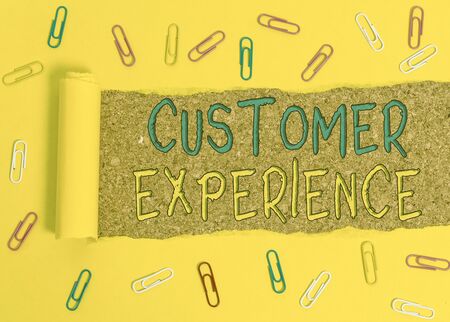 Text sign showing Customer Experience. Business photo text product of an interaction between a client and customer Paper clip and torn cardboard placed above a wooden classic table backdropの写真素材