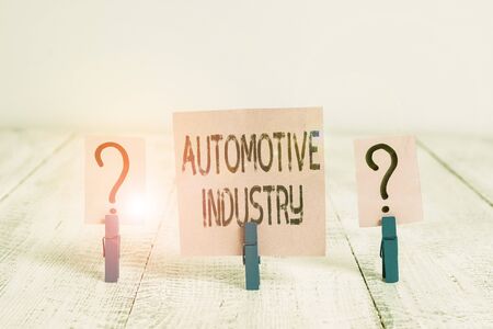 Text sign showing Automotive Industry. Business photo showcasing organizations involved in the business of motor vehicles Scribbled and crumbling sheet with paper clips placed on the wooden tableの写真素材