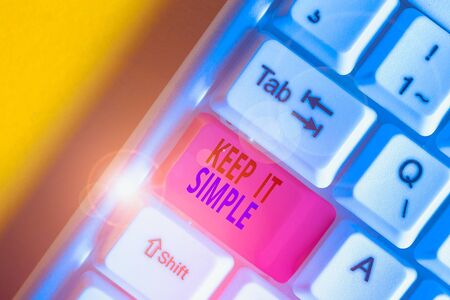 Handwriting text Keep It Simple. Conceptual photo Easy to toss around Understandable Generic terminology White pc keyboard with empty note paper above white background key copy spaceの写真素材