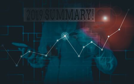Word writing text 2019 Summary. Business photo showcasing summarizing past year events main actions or good shows Woman wear formal work suit present presentation using smart latest deviceの写真素材