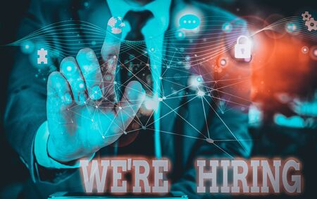 Writing note showing We Re Hiring. Business concept for process of reviewing applications and finding candidates Picture photo network scheme with modern smart deviceの写真素材