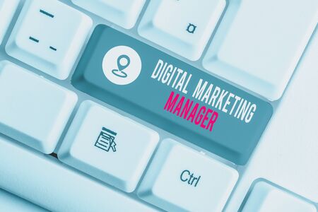 Conceptual hand writing showing Digital Marketing Manager. Concept meaning optimized for posting in online boards or careers White pc keyboard with note paper above the white backgroundの写真素材