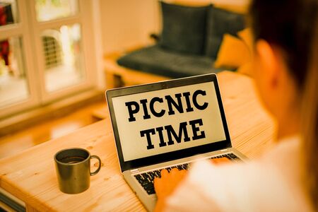 Writing note showing Picnic Time. Business concept for period where meal taken outdoors as part of an excursion woman laptop computer office supplies technological devices inside homeの写真素材