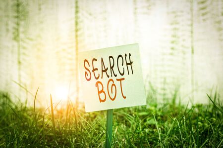 Text sign showing Search Bot. Business photo showcasing a program that runs automated tasks over the Internet or network Plain empty paper attached to a stick and placed in the green grassy landの写真素材