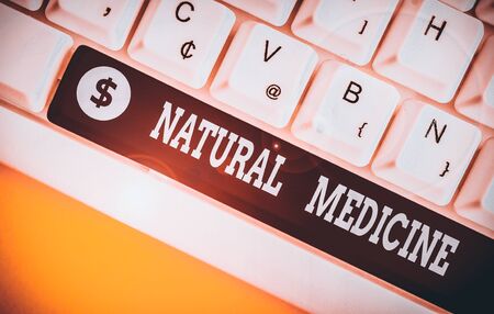 Handwriting text Natural Medicine. Conceptual photo any of various systems of healing or treating disease White pc keyboard with empty note paper above white background key copy spaceの写真素材