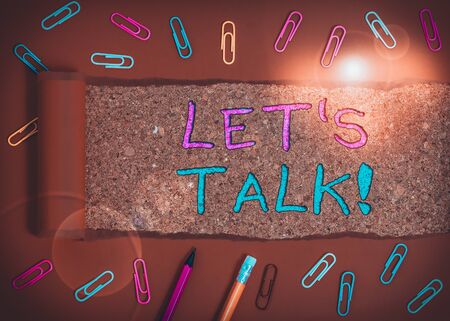 Word writing text Let S Is Talk. Business photo showcasing suggesting in the beginning of a conversation on the topic Stationary and torn cardboard placed above a wooden classic table backdropの写真素材