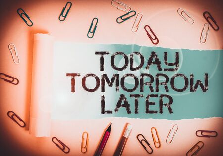 Writing note showing Today Tomorrow Later. Business concept for Presently Currently Future Soon Afterwards Following Stationary and torn cardboard placed above plain pastel table backdropの写真素材