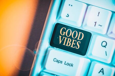 Handwriting text Good Vibes. Conceptual photo slang phrase for the positive feelings given off by a demonstrating White pc keyboard with empty note paper above white background key copy spaceの写真素材