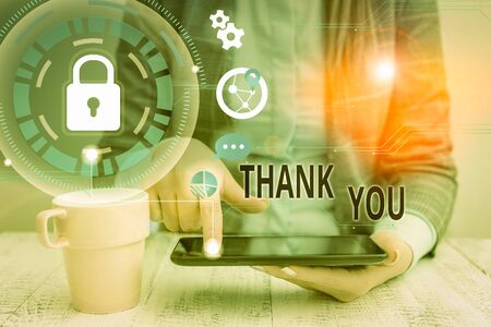 Conceptual hand writing showing Thank You. Concept meaning a polite expression used when acknowledging a gift or service Female human wear formal work suit presenting smart deviceの写真素材