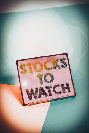 Word writing text Stocks To Watch. Business photo showcasing being heavy broker and watch every increase decrease Paper placed tilted above buffer wire on soft pastel multi colours backdropの写真素材