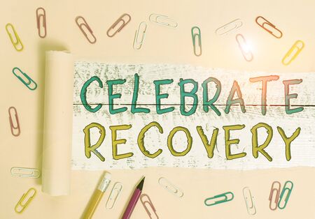 Text sign showing Celebrate Recovery. Business photo showcasing recovery program for anyone struggling with hurt or pain Stationary and torn cardboard placed above a wooden classic table backdropの写真素材