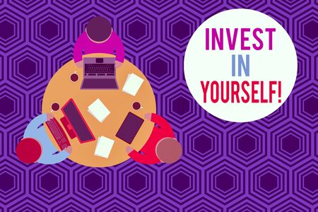 Writing note showing Invest In Yourself. Business concept for learn new things or materials thus making your lot better Working table male employees electronic devices coffee cupの写真素材