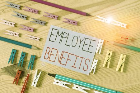Text sign showing Employee Benefits. Business photo text indirect and noncash compensation paid to an employee Colored clothespin papers empty reminder wooden floor background officeの写真素材