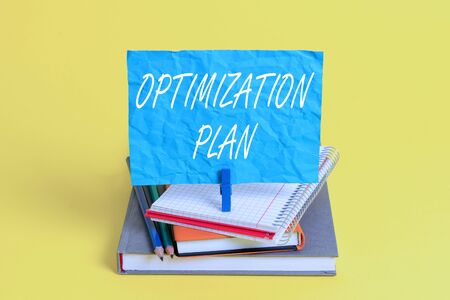 Word writing text Optimization Plan. Business photo showcasing Finding an alternative with the most cost effective Book pencil rectangle shaped reminder notebook clothespin office suppliesの写真素材
