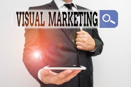 Word writing text Visual Marketing. Business photo showcasing telling the story of your brand or product by creation Male human wear formal work suit hold smart hi tech smartphone use one handの写真素材