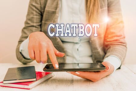 Writing note showing Chatbot. Business concept for a kind of computer program that simulates human conversation Business concept with communication mobile phoneの写真素材