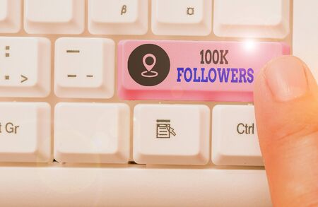 Conceptual hand writing showing 100K Followers. Concept meaning number of individuals who follows someone on social mediaの写真素材