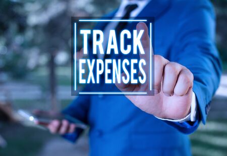 Handwriting text writing Track Expenses. Conceptual photo keep a close eye on how things are tracking to budget Businessman with pointing finger in front of himの写真素材