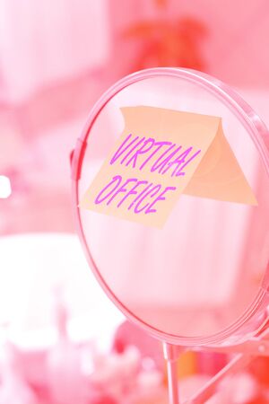Text sign showing Virtual Office. Business photo showcasing Mobile workenvironment equipped with telecommunication links Round shape mirror and toiletries placed next to sink in a modern bathroomの写真素材