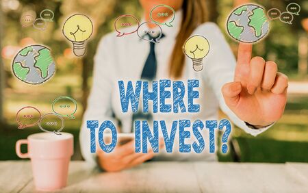 Writing note showing Where To Invest Question. Business concept for asking about where put money into financial schemes or sharesの写真素材