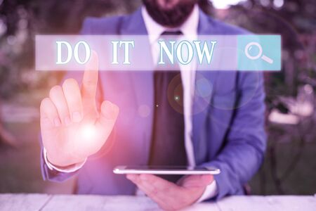 Word writing text Do It Now. Business photo showcasing not hesitate and start working or doing stuff right awayの写真素材