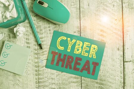 Writing note showing Cyber Threat. Business concept for has a potential to cause serious harm to a computer system Crumpled paper in bin and computer mouse on wooden backdrop.の写真素材
