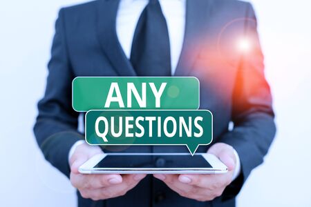 Conceptual hand writing showing Any Questions. Concept meaning Something that you say or write in order to ask a demonstrating Male human wear formal work suit hold hitech smartphoneの写真素材