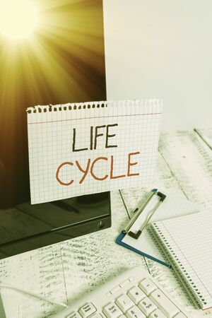 Writing note showing Life Cycle. Business concept for the series of changes in the life of an organism and animals Note paper taped to black computer screen near keyboard and stationaryの写真素材
