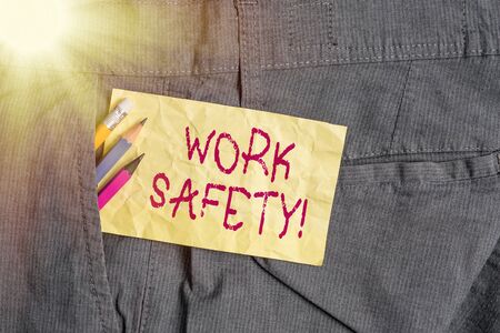 Word writing text Work Safety. Business photo showcasing policies and procedures in place to ensure health of employees Writing equipment and yellow note paper inside pocket of man work trousersの写真素材