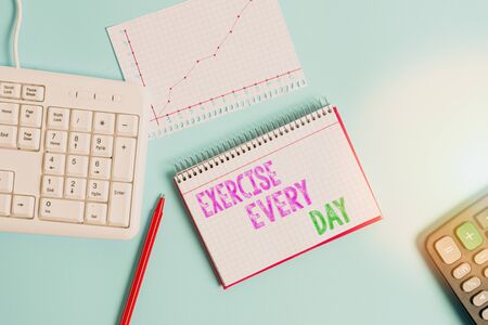 Text sign showing Exercise Every Day. Business photo text move body energetically in order to get fit and healthy Paper blue desk computer keyboard office study notebook chart numbers memoの写真素材