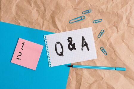 Handwriting text writing Q And A. Conceptual photo a period of time or an occasion when someone answers questions Papercraft craft paper desk square spiral notebook office study suppliesの写真素材