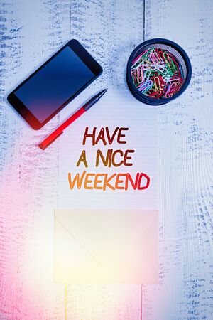 Writing note showing Have A Nice Weekend. Business concept for wishing someone that something nice happen holiday Smartphone paper sheet clips pen envelope wooden vintage backgroundの写真素材