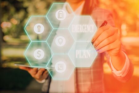 Writing note showing Emergency Plan. Business concept for actions developed to mitigate damage of potential eventsの写真素材