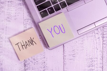 Text sign showing Thank You. Business photo showcasing a polite expression used when acknowledging a gift or service Trendy silver metallic laptop two sticky note pads lying vintage tableの写真素材