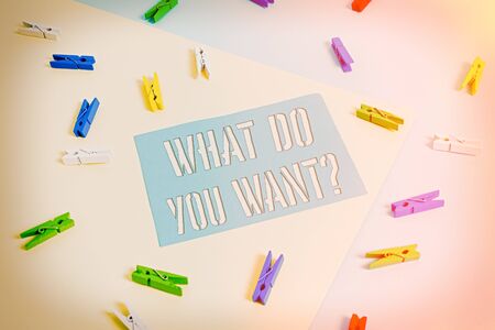 Writing note showing What Do You Want Question. Business concept for say or write in order to ask demonstrating about something Colored clothespin paper reminder with yellow blue backgroundの写真素材